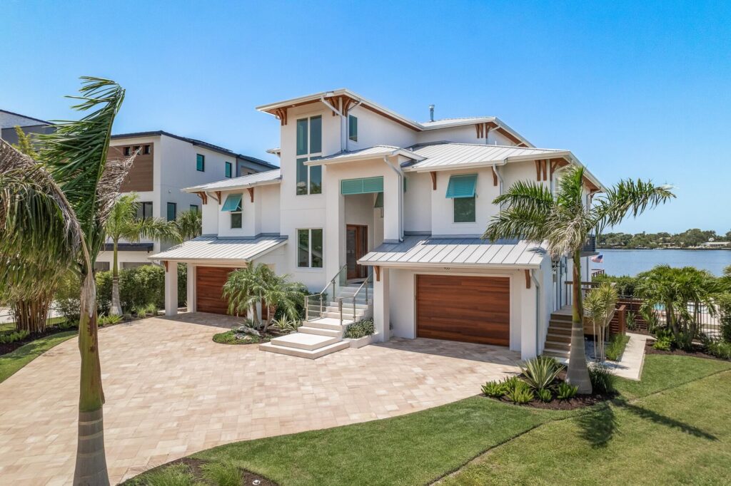 Elevated waterfront custom home with garage and entry at ground level